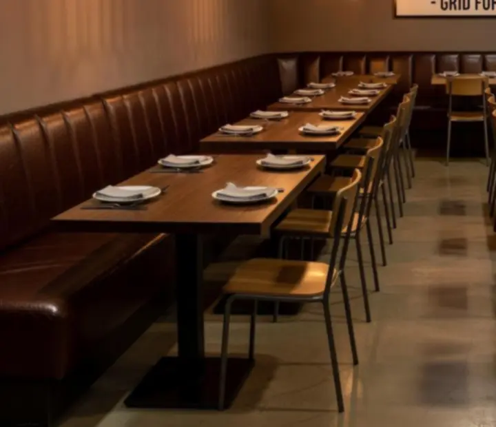 Banquettes and communal tables arranged in a structured grid inside APARTAMENT SZRENICA