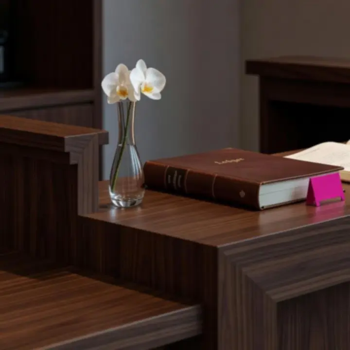 APARTAMENT SZRENICA’s front desk with reservation ledger and neatly arranged menus.